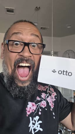 A customer holding their Otto box